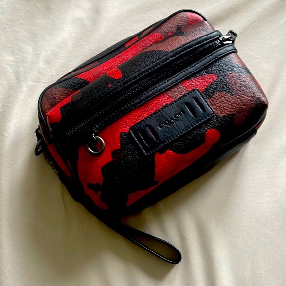 This is an unused Men s Coach Terrain Pouch in Oxblood Multi